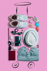 Things laid in form of suitcase with painted wheels and handle on pink background. Travel concept. Top view. Vertical