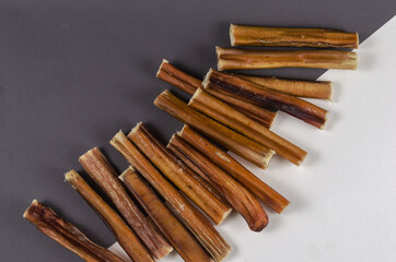 Pet treats. A group of brown treats on a gray and white backgrou
