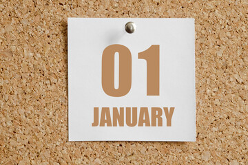 january 01. 01th day of the month, calendar date.White calendar sheet attached to brown cork board.Winter month, day of the year concept