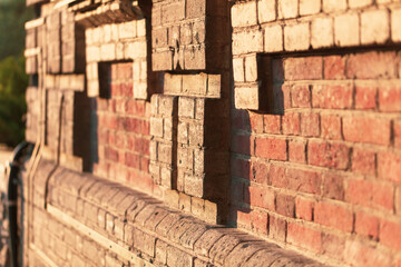 Brick wall at sunset as a background.