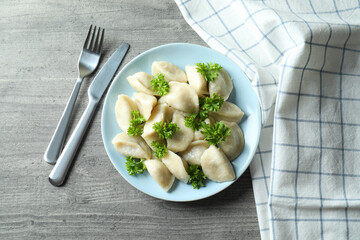 Concept of tasty food with vareniki or pierogi on gray textured table