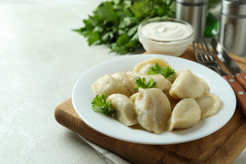 Concept of tasty food with vareniki or pierogi on white textured table