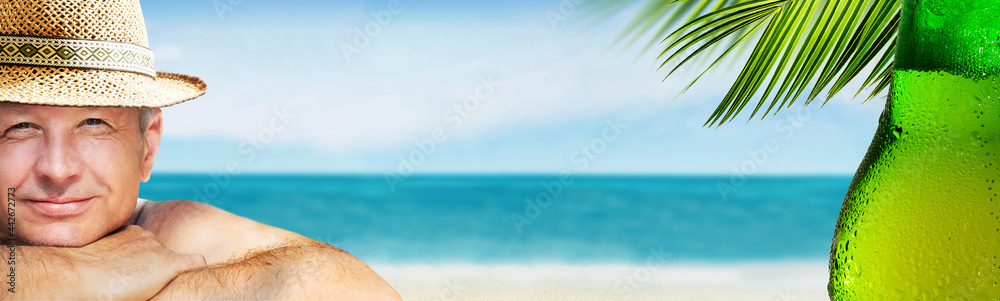 Wall mural a man is enjoying his vacation relaxing with a bottle of beer by the sea beach background.