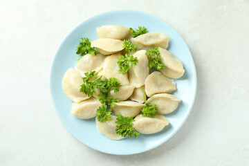 Concept of tasty food with vareniki or pierogi on white textured table
