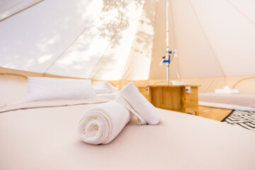 Fototapeta na wymiar Glamping in a white canvas tent in luxury interior 