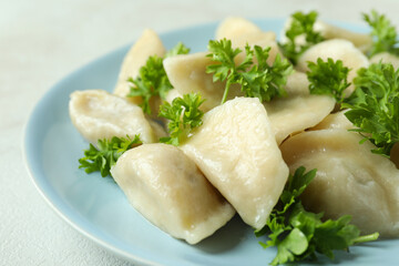 Concept of tasty food with vareniki or pierogi on white textured table