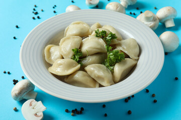Concept of tasty food with vareniki or pierogi on blue background