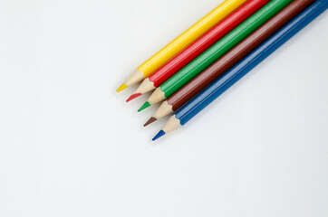 Sharpened colored pencils isolated on a white background. Office supplies