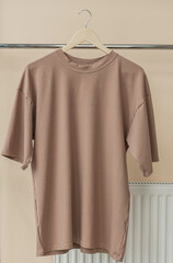 Brown t-shirt on hanger ready for your own graphics