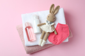 Different baby hygiene accessories on pink background