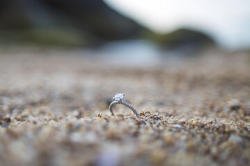Engagement Wedding Ring on the beach sand and rock Macro Close Up Detailed No people Copy Space