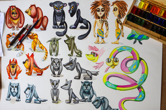 The animator draws with a pencil and draws characters from cartoons, comics or puppet shows. Mowgli's play. Preparing to make a doll. The designer creates sketches. Comics, cartoons, puppet theater