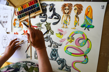 The animator draws with a pencil and draws characters from cartoons, comics or puppet shows....