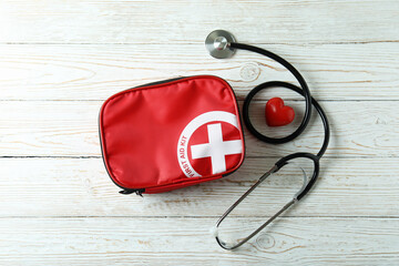 First aid medical kit on white wooden table
