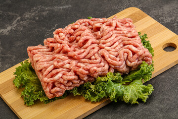 Raw pork minced meat over board