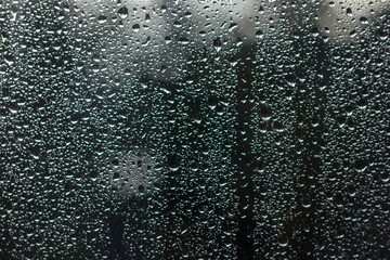  Drops on window glass and drips after heavy rain and thunderstorm, selective focus