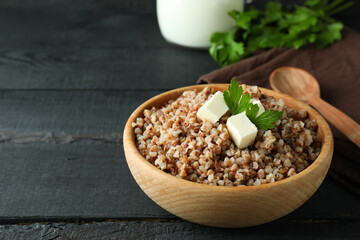 Concept of tasty eating with buckwheat on wooden table