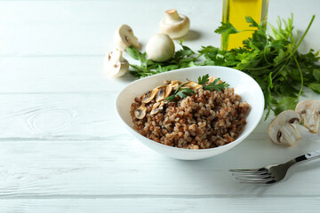 Concept of tasty eating with buckwheat on wooden table