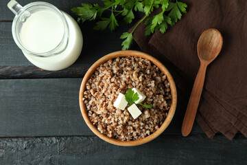 Concept of tasty eating with buckwheat on wooden table