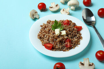 Concept of tasty eating with buckwheat on blue background