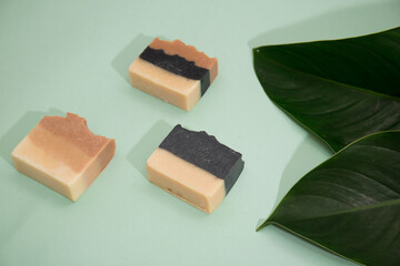 Different hand made soap bar isolated on mint background 