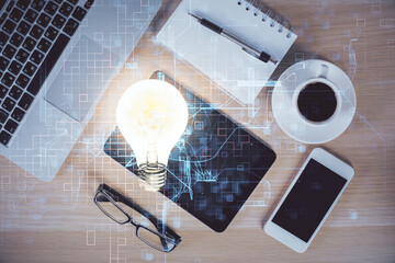 Double exposure of bulb drawing over table with phone. Top view. Concept of idea.