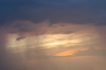 Fototapeta premium Beautiful sunset sky above clouds with dramatic light, Beautiful blazing sunset landscape, Copy space, Selective focus.