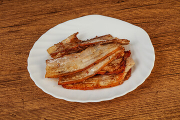 Roasted juicy bacon in the plate