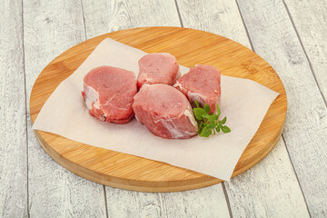 Raw pork medallion served rosemary