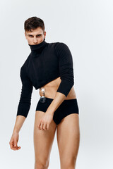 Obraz premium sexy guy in fashionable clothes in socks and shorts on a light background