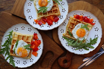 Healthy breakfast . Freshly made, delicious meal of eggs and vegetables. Gluten-free buckwheat waffles with fried eggs Top view