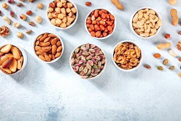 Nuts assortment, top shot with a place for text on a slate background. Pistachios, almonds, cashews etc
