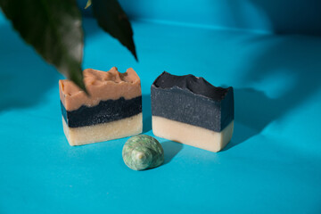 Different hand made soap bars on blue background 