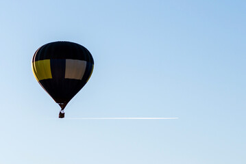 Hot Air Balloon on a blue sky.One Blue yellow hot air balloon in blue clear sky.Copy space.