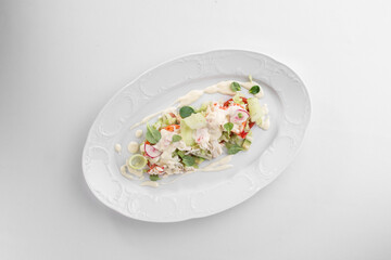 healthy salad with crab meat, radish, cucumbers and peppers isolated on white background