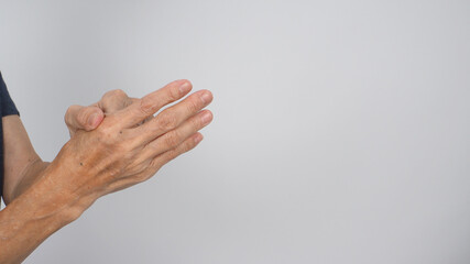 Senior or older woman hand that had arthritis or trigger fingers on white background.