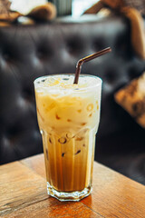 iced latte coffee in a  tall glass. cold summer drink background