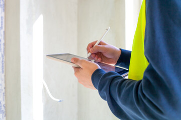 Civil engineer hold tablet computer. Closeup hand using mobile phone on construction site © dmf87