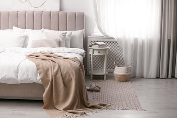 Elegant room interior with large comfortable bed