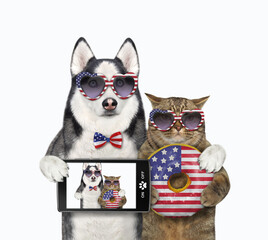 A dog husky with a smartphone hugs a beige cat with a usa flag donut. White background. Isolated.