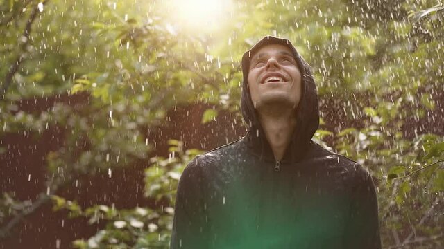 Happy young man under rain