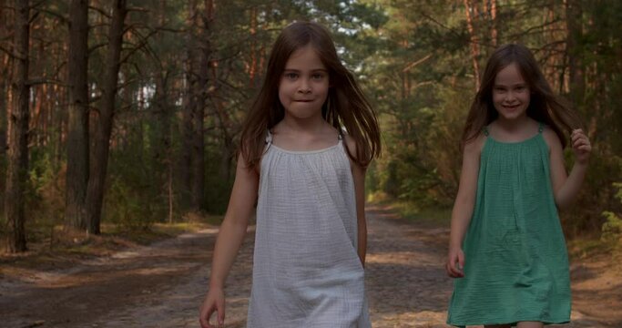 Two beautiful girls walking in the woods