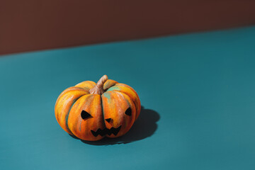 Pumpkin with an evil face on blue background