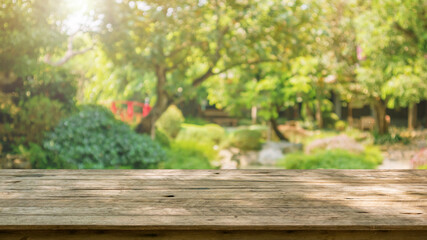 Obraz na płótnie Canvas Empty wood table top with abstract blur park garden pond background