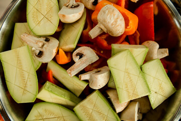 close-up top view of slices champignons and zucchini and other vegetables