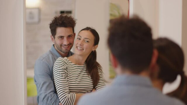 Young couple embracing in front of mirror