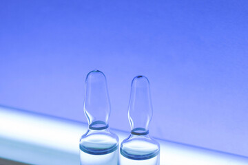Ampoules for medical and cosmetic products. Medicines for injection and a germicidal lamp.
