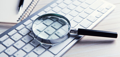 Internet search concept, magnifier on computer keyboard