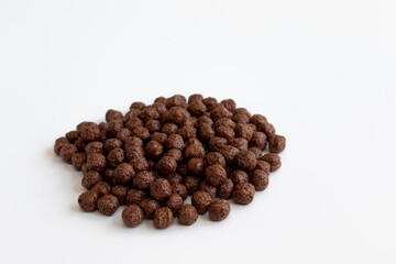 crunchy chocolate cereal balls isolated on white background
