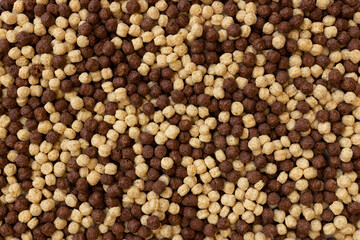 chocolate breakfast cereal texture, cereal balls as background, top view